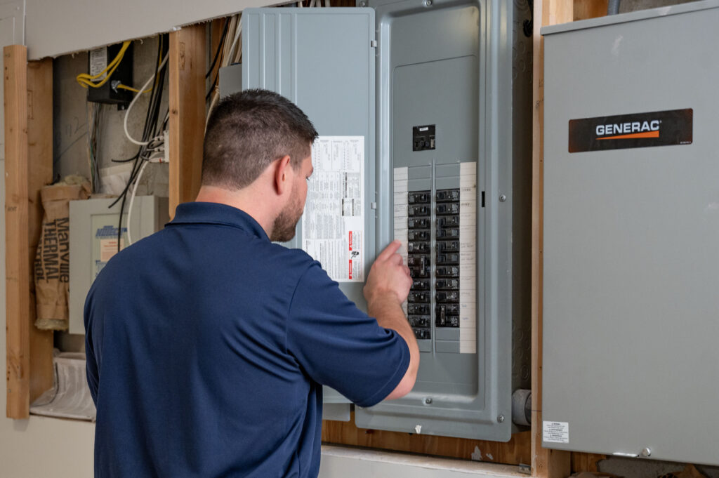Electrician providing electrical service on a panel