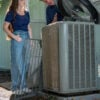 Canfield HVAC technician explaining air conditioning maintenance to a homeowner in Grand Rapids